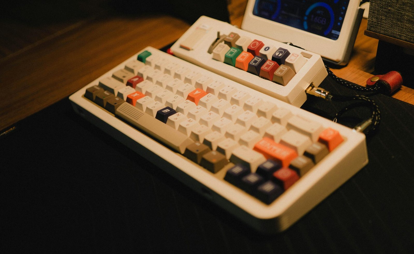 Vintage mechanical keyboard with colorful keys on a wooden desk, evoking a classic gaming setup.